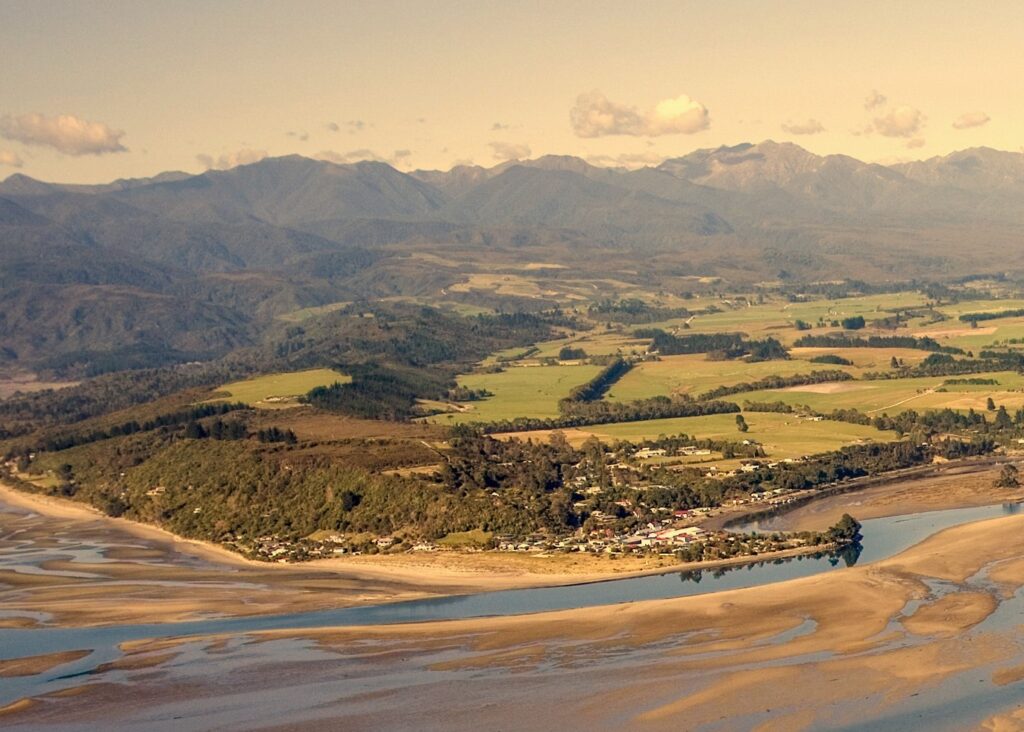 Golden Bay’s sweeping tidal flats and lush farmland with mountain ranges in the background.