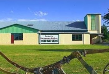 Exterior view of the Rockville Machinery & Settlers Museum building with a large sign on the wall.