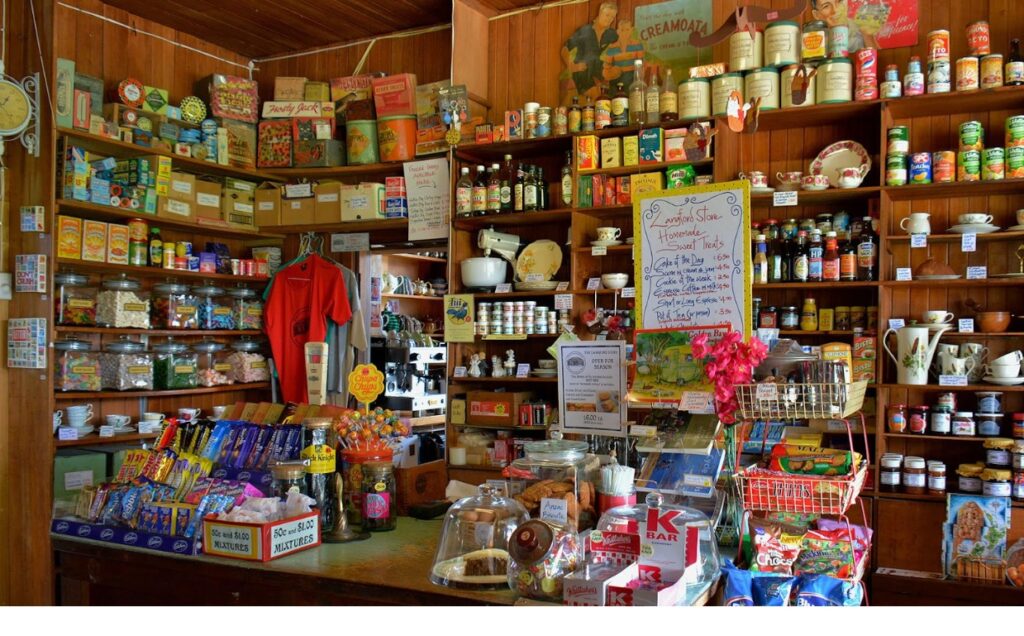 Interior of the Langford Store in Golden Bay, featuring shelves filled with groceries, lollies, vintage tins, and handmade treats.