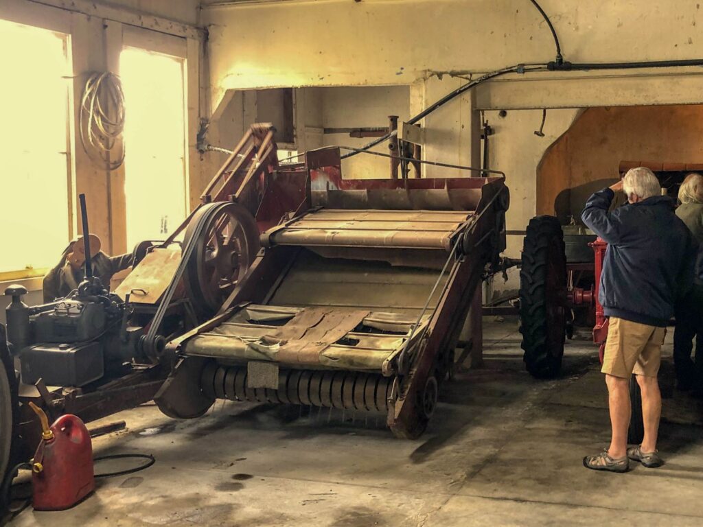 Vintage hay baler and tractor display inside the Rockville Museum near Collingwood, Golden Bay.