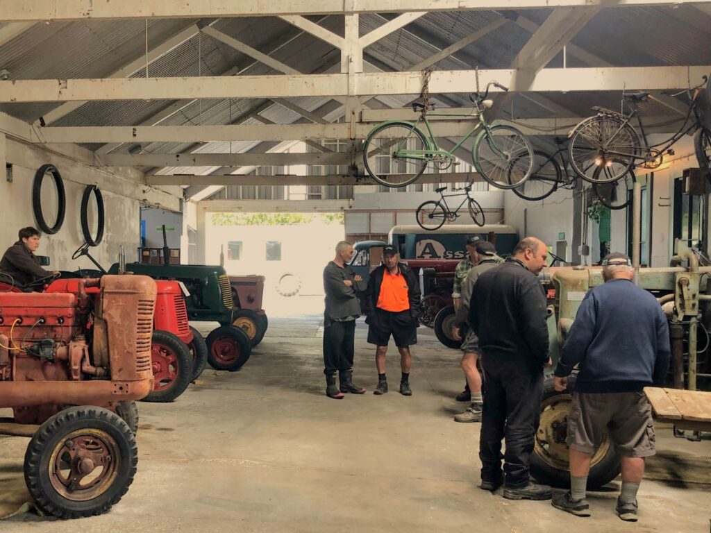 Visitors explore vintage tractors and machinery inside the Rockville Machinery & Settlers Museum in Golden Bay.